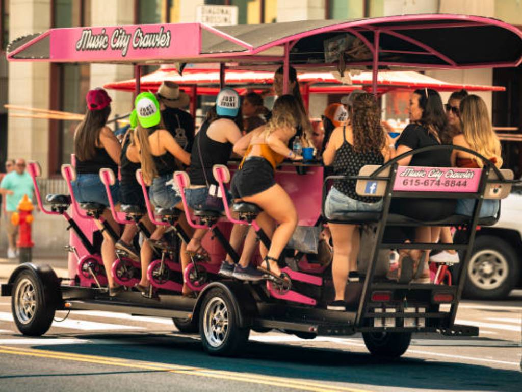 Group seated at the bar of a 15-person pedal-powered party bike