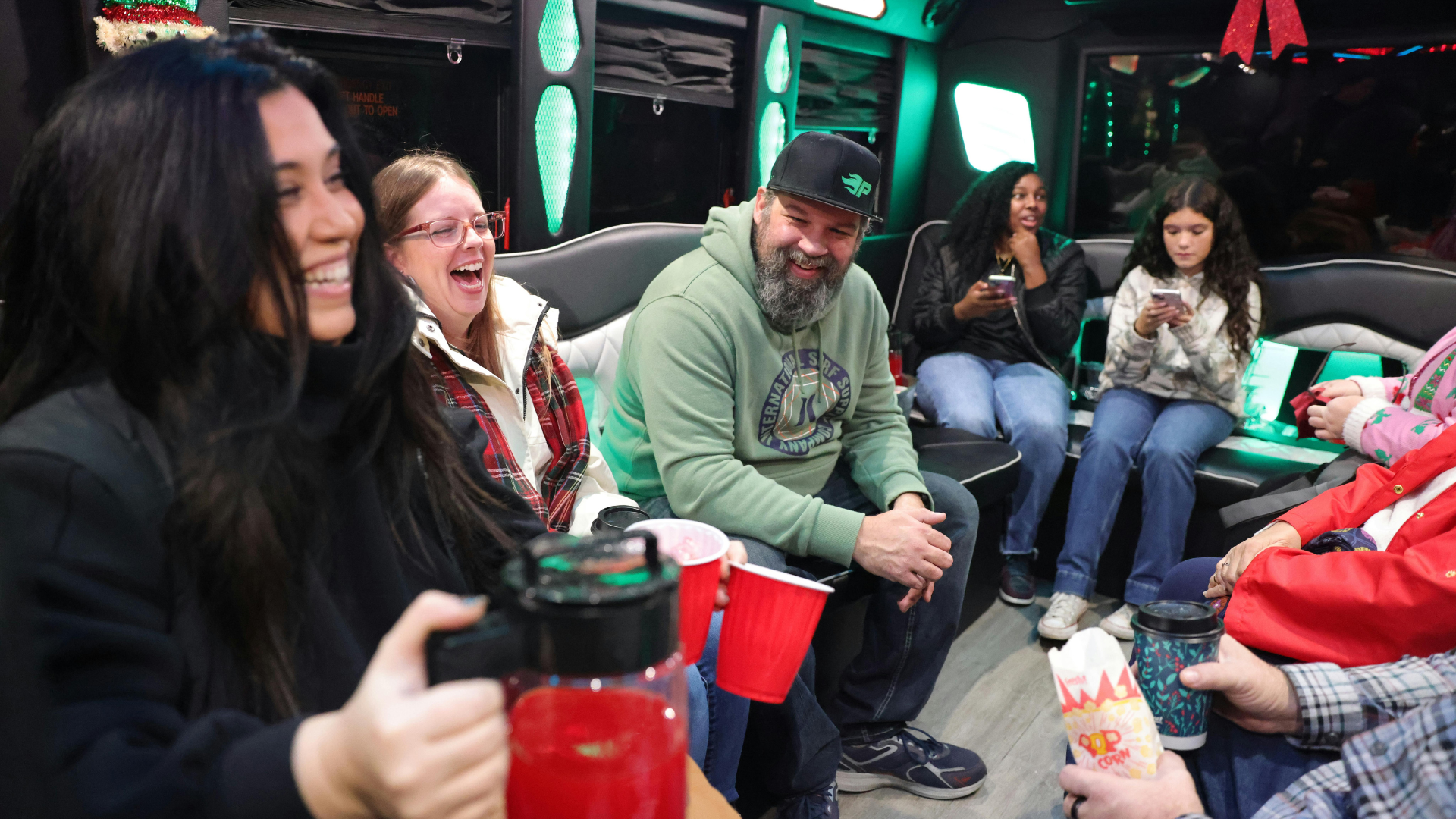 Group seated around the booths of the party bus during an afternoon tea party run
