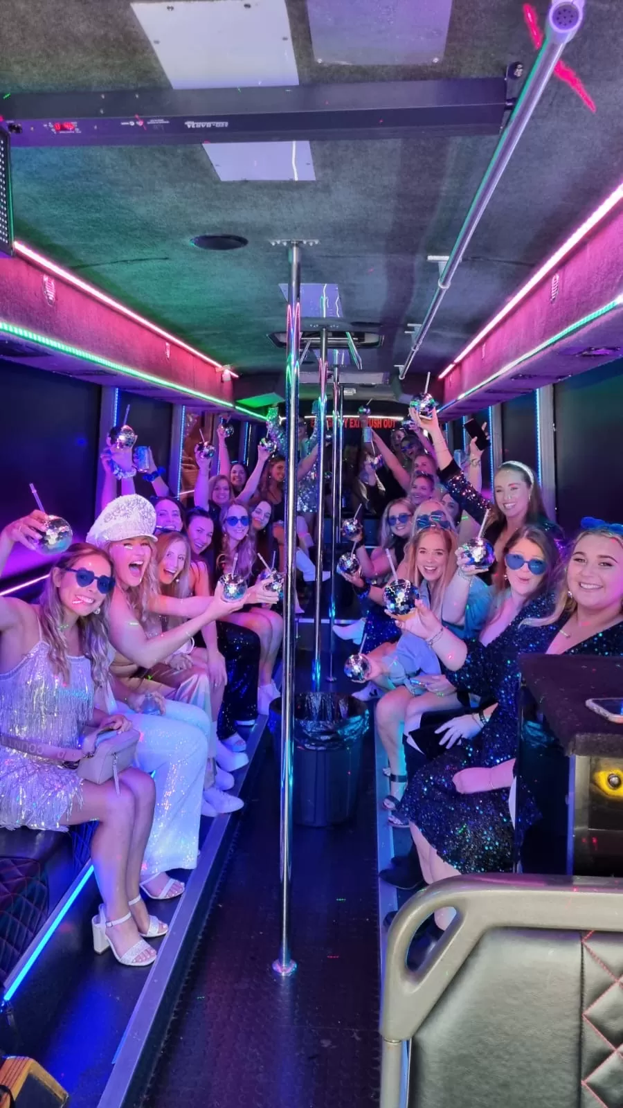 Hen party bus hire — hen group celebrating on board with disco lighting
