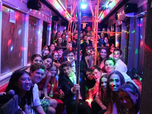 Debs party bus hire — students in formal wear on board the party bus